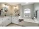 Bright main bathroom with a soaking tub and dual sinks at 121 Colonial Sw St, Port Charlotte, FL 33952