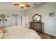 Spacious main bedroom with wood floors, a large dresser, and private access to the main bathroom at 121 Colonial Sw St, Port Charlotte, FL 33952