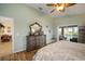 Spacious main bedroom with wood floors, a large dresser, and private access to outdoor space at 121 Colonial Sw St, Port Charlotte, FL 33952