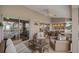 Relaxing covered patio with comfortable seating, a dining table, and view of the pool at 121 Colonial Sw St, Port Charlotte, FL 33952