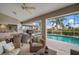 Covered patio featuring a dining area, cozy seating, and a view of the refreshing pool at 121 Colonial Sw St, Port Charlotte, FL 33952