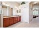 Bathroom with double sinks and dark wooden vanity at 1430 Beaconsfield Dr, Wesley Chapel, FL 33543
