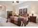 Bright bedroom with a ceiling fan and stained glass above window at 1430 Beaconsfield Dr, Wesley Chapel, FL 33543
