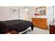 Bedroom featuring hardwood floors, a wooden dresser, and neutral walls at 1430 Beaconsfield Dr, Wesley Chapel, FL 33543