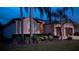 View of the exterior of a home with manicured landscaping, healthy bushes, and lush green grass at 1430 Beaconsfield Dr, Wesley Chapel, FL 33543