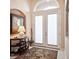 Elegant foyer featuring decorative painting, tiled flooring, and a view of the double doors at 1430 Beaconsfield Dr, Wesley Chapel, FL 33543