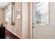 View of the foyer, showcasing a front door, with natural light, dark floors and neutral walls at 1430 Beaconsfield Dr, Wesley Chapel, FL 33543