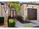Inviting home entrance with double doors, decorative shrubbery, and stylish exterior lighting fixtures at 1430 Beaconsfield Dr, Wesley Chapel, FL 33543