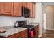 Cozy kitchen with wood cabinetry, granite countertops and stainless steel appliances at 1430 Beaconsfield Dr, Wesley Chapel, FL 33543
