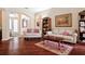 Inviting living room featuring hardwood floors, comfortable seating, and a doorway at 1430 Beaconsfield Dr, Wesley Chapel, FL 33543