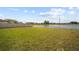 Beautiful yard with a scenic pond view, complemented by a privacy fence at 1547 Golden Glow Dr, Ruskin, FL 33570