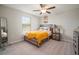 Comfortable bedroom featuring a ceiling fan, window, and nightstand with a lamp at 1547 Golden Glow Dr, Ruskin, FL 33570