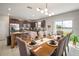 Dining area with a view of the kitchen, elegantly set table and ample natural light from the sliding glass door at 1547 Golden Glow Dr, Ruskin, FL 33570