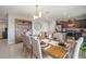 Dining room with kitchen view, elegant lighting, and stylish decor, ideal for hosting dinner parties at 1547 Golden Glow Dr, Ruskin, FL 33570