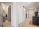 Hallway featuring white sliding doors and neutral walls, showcasing a clean and modern design at 1547 Golden Glow Dr, Ruskin, FL 33570