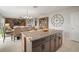Kitchen island with granite countertops and a view of the open-plan dining and living areas at 1547 Golden Glow Dr, Ruskin, FL 33570