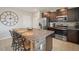 Well-equipped kitchen showcasing a large island with granite countertop and stainless steel appliances at 1547 Golden Glow Dr, Ruskin, FL 33570