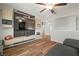 Stylish living room with custom shelving, entertainment center, and a large TV at 1547 Golden Glow Dr, Ruskin, FL 33570