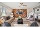 Comfortable living room with wooden accent wall, a ceiling fan and ample seating, creating a cozy atmosphere at 1547 Golden Glow Dr, Ruskin, FL 33570