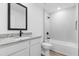Bathroom with white subway tile, white vanity and granite countertop, and black fixtures at 1721 Shevlin St, North Port, FL 34286