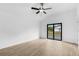 Bright bedroom featuring a ceiling fan and sliding glass door leading to the backyard at 1721 Shevlin St, North Port, FL 34286