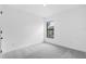 Simple bedroom with plush carpet and a window with a view of the outside at 1721 Shevlin St, North Port, FL 34286