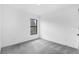 Neutral bedroom with plush carpet, bright white walls, and window with natural light at 1721 Shevlin St, North Port, FL 34286