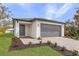 Lovely single-story home boasting a well-manicured lawn, fresh landscaping, and a gray garage door at 1721 Shevlin St, North Port, FL 34286