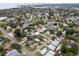 Drone shot of the property in a residential area with mature trees and city views at 1759 Massachusetts Ne Ave, St Petersburg, FL 33703