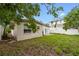 Spacious backyard with a small patio and mature trees, providing a peaceful retreat at 1759 Massachusetts Ne Ave, St Petersburg, FL 33703