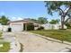 Charming single-story home featuring a well-maintained lawn and an attached one-car garage at 1759 Massachusetts Ne Ave, St Petersburg, FL 33703