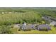 A serene aerial view of townhouse exteriors nestled amidst lush trees and a tranquil pond at 18236 Paradise Point Dr, Tampa, FL 33647
