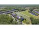 Aerial view of complex showcasing its pond, golf course, and manicured grounds at 18236 Paradise Point Dr, Tampa, FL 33647
