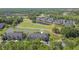 Aerial view of a community with pond, golf course, and lush landscaping at 18236 Paradise Point Dr, Tampa, FL 33647