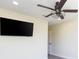 Bedroom with a ceiling fan and mounted TV provides a relaxing and comfortable space at 18236 Paradise Point Dr, Tampa, FL 33647
