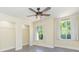 Bright bedroom with large windows offering serene views of the surrounding landscape at 18236 Paradise Point Dr, Tampa, FL 33647