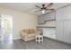 Bonus room featuring modern floors, couch, ceiling fan, and built in shelving at 18236 Paradise Point Dr, Tampa, FL 33647