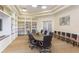 Spacious conference room with large table, comfortable chairs, and built-in bookshelves for meetings and collaboration at 18236 Paradise Point Dr, Tampa, FL 33647