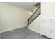 Bright entryway featuring modern gray floors, stairway with black railings, and built in storage at 18236 Paradise Point Dr, Tampa, FL 33647