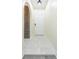 Inviting entryway with stylish tile flooring, arched doorway, and elegant lighting fixture at 18236 Paradise Point Dr, Tampa, FL 33647