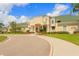 Stunning exterior of community clubhouse with palm trees, manicured lawn, and beautiful landscaping at 18236 Paradise Point Dr, Tampa, FL 33647