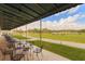 Practice your game with a covered area overlooking the driving range, featuring scenic golf course views at 18236 Paradise Point Dr, Tampa, FL 33647
