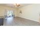 Living room featuring modern floors, curtains, sliding glass doors to patio, and ceiling fan at 18236 Paradise Point Dr, Tampa, FL 33647