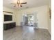 Living room featuring modern floors, curtains, sliding glass doors to patio, and ceiling fan at 18236 Paradise Point Dr, Tampa, FL 33647