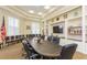 Conference room with large table, comfortable seating, built-in shelves, and a large screen TV at 18236 Paradise Point Dr, Tampa, FL 33647