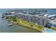 Aerial view shows the building, expansive lawns, a pool and a dock at 1847 Shore S Dr # 507, South Pasadena, FL 33707