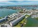 Aerial view of the condo building located near waterfront with city and beaches in background at 1847 Shore S Dr # 507, South Pasadena, FL 33707