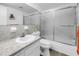 Traditional bathroom with a white vanity, decorative mirror and shower with sliding glass doors at 1847 Shore S Dr # 507, South Pasadena, FL 33707
