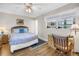 Bedroom showcasing window with sheer curtains, wood floors, desk, and comfortable sleeping area at 1847 Shore S Dr # 507, South Pasadena, FL 33707