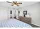 Cozy bedroom featuring ceiling fan, closet space, and dresser with decorative mirror and lamps at 1847 Shore S Dr # 507, South Pasadena, FL 33707